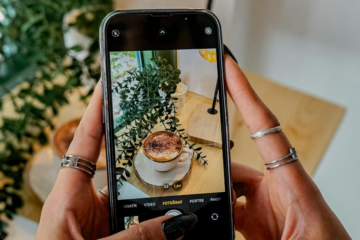 persona tomando fotografía a un café para subir a redes sociales con plantas al rededor como idea para subir a redes sociales